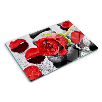 Planche à découper verre Rose sur pierres avec gouttes d'eau