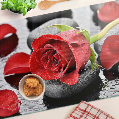 Planche à découper verre Rose sur pierres avec gouttes d'eau