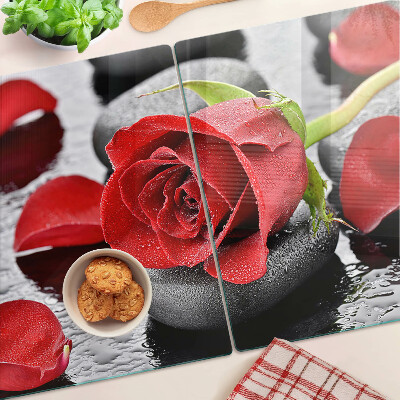 Planche à découper verre Rose sur pierres avec gouttes d'eau