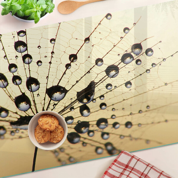 Planche à découper en verre Gouttes d'eau sur une toile d'araignée