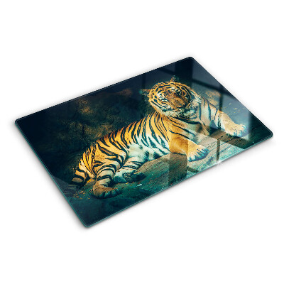 Planche à découper verre Un tigre couché sur les rochers