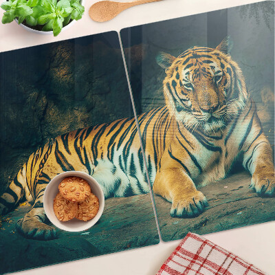 Planche à découper verre Un tigre couché sur les rochers