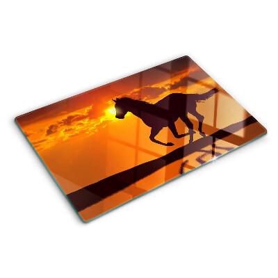 Planche à découper verre Un cheval sur fond de soleil couchant