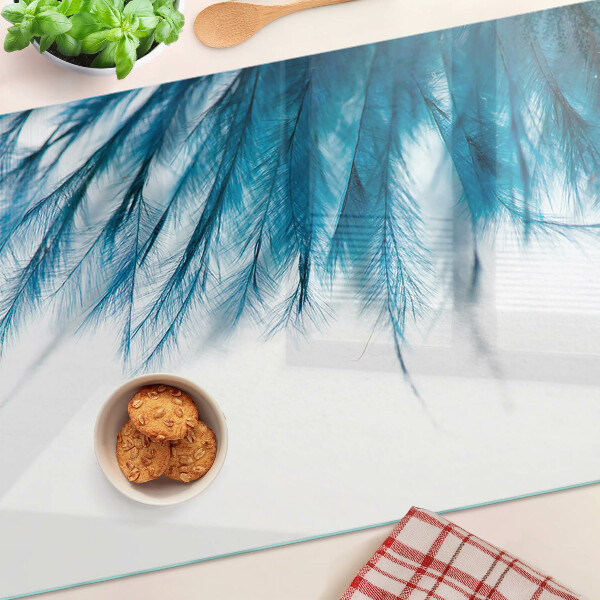Planche à découper en verre Plumes bleues sur fond blanc