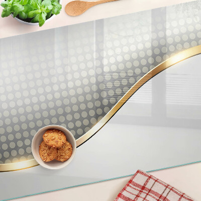 Planche à découper en verre Une vague dorée sur un fond de points