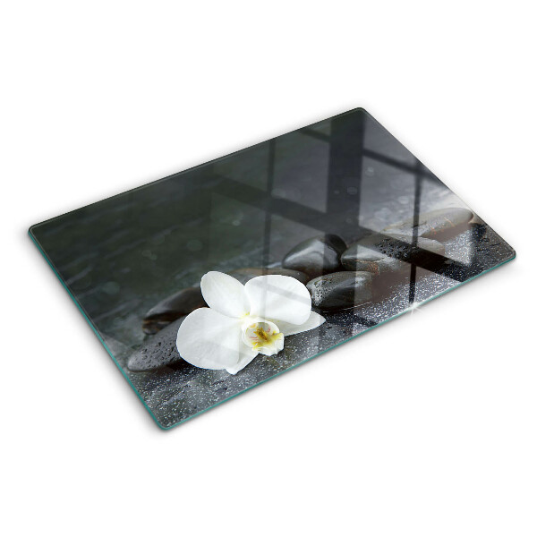Planche à découper en verre Fleur d'orchidée sur pierres