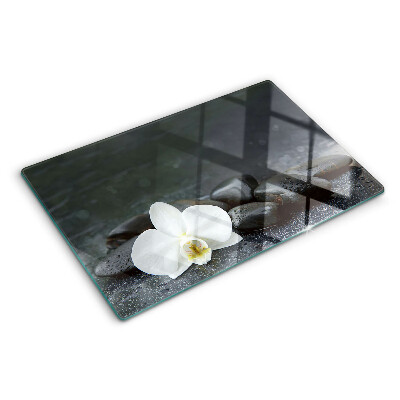 Planche à découper en verre Fleur d'orchidée sur pierres
