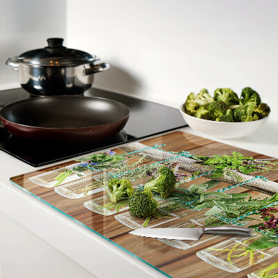 Planche à découper en verre Herbes en pots sur fond de bois