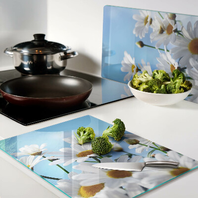 Planche à découper en verre Fleurs de marguerite sur fond bleu