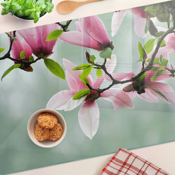 Planche à découper en verre Fleurs de magnolia sur fond de verdure