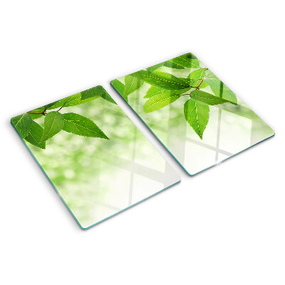 Planche à découper en verre Feuilles sur fond de verdure floue