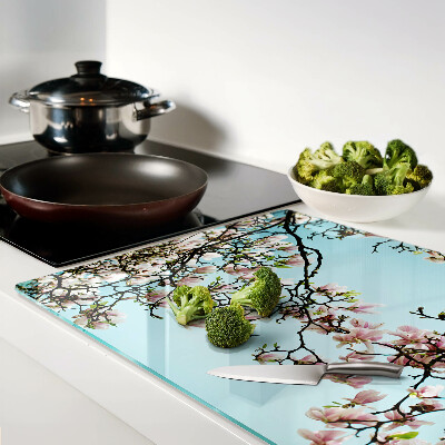 Planche à découper verre Fleurs de magnolia sur fond bleu