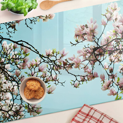 Planche à découper verre Fleurs de magnolia sur fond bleu