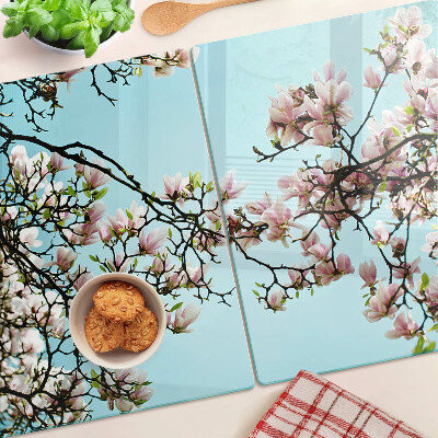 Planche à découper verre Fleurs de magnolia sur fond bleu