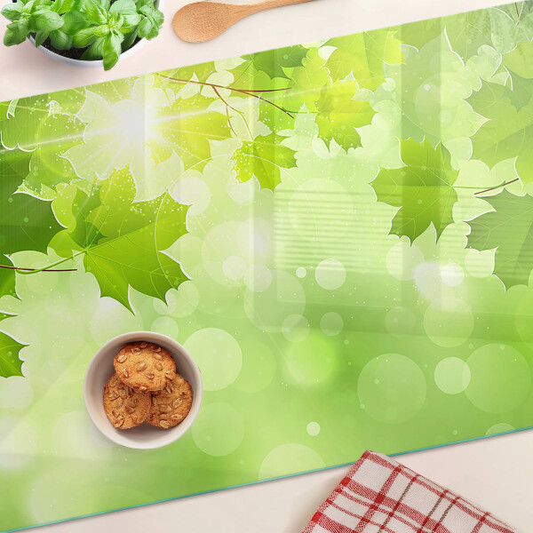 Planche à découper en verre Feuilles aux rayons du soleil