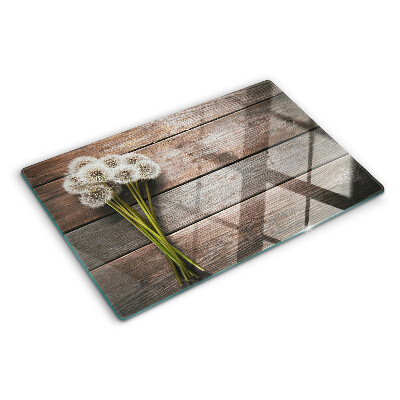 Planche à découper en verre Fleurs de pissenlit sur fond de bois