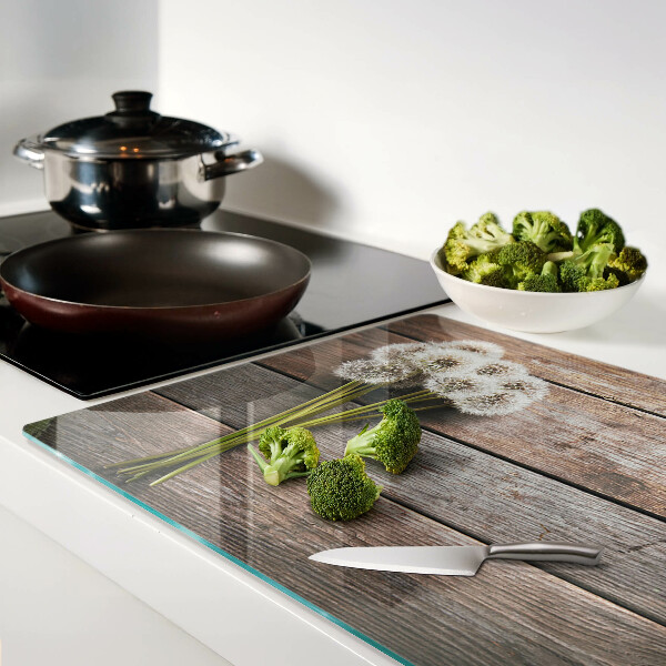 Planche à découper en verre Fleurs de pissenlit sur fond de bois