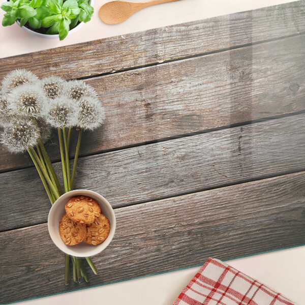 Planche à découper en verre Fleurs de pissenlit sur fond de bois
