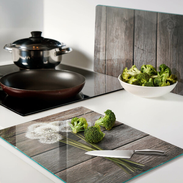 Planche à découper en verre Fleurs de pissenlit sur fond de bois