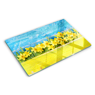 Planche à découper en verre Fleurs de jonquilles contre le ciel