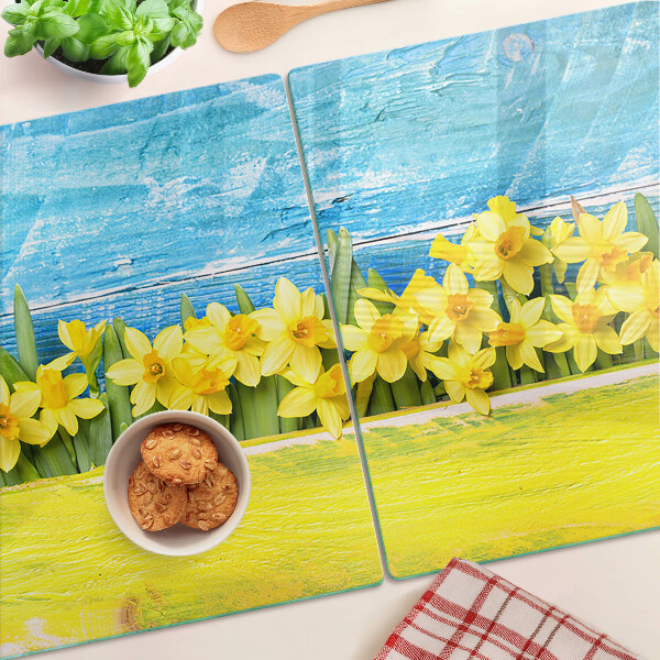 Planche à découper en verre Fleurs de jonquilles contre le ciel