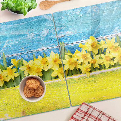 Planche à découper en verre Fleurs de jonquilles contre le ciel