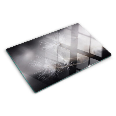 Planche à découper en verre Pissenlits duveteux sur fond de fenêtre