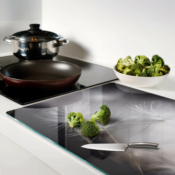 Planche à découper en verre Pissenlits duveteux sur fond de fenêtre