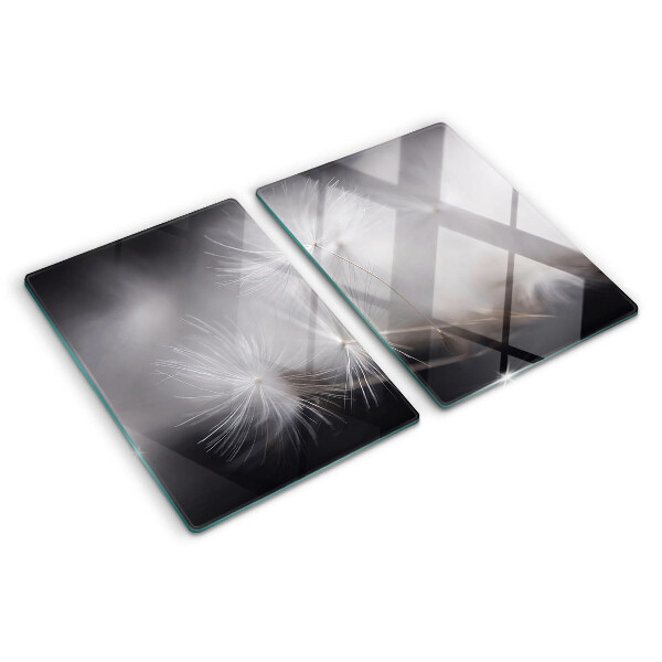 Planche à découper en verre Pissenlits duveteux sur fond de fenêtre