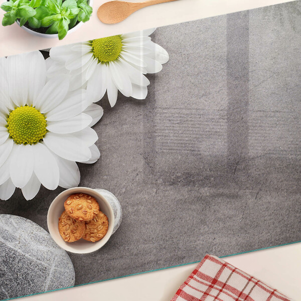 Planche à découper verre Fleurs et pierres en arrière-plan