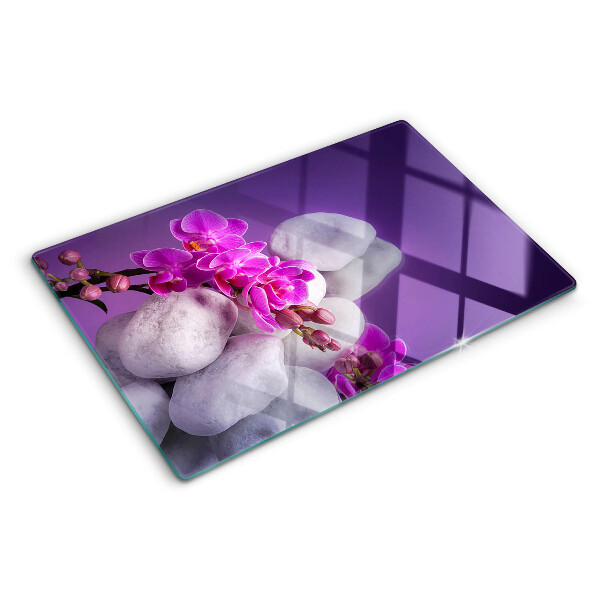 Planche à découper verre Fleurs d'orchidées sur fond de pierres
