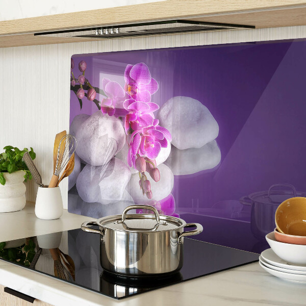 Planche à découper verre Fleurs d'orchidées sur fond de pierres