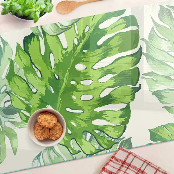 Planche à découper en verre Feuilles de Monstera sur fond clair