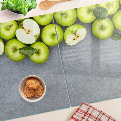 Planche à découper verre Pommes vertes sur une surface grise