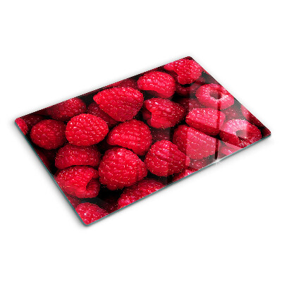 Planche à découper verre Des framboises en arrière-plan