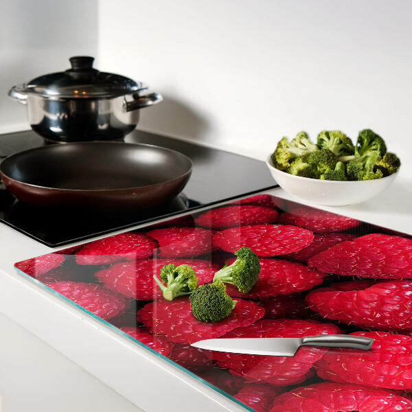 Planche à découper verre Des framboises en arrière-plan