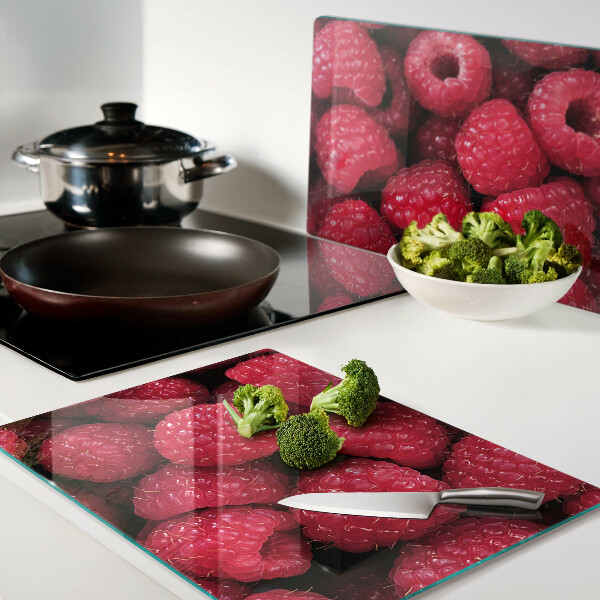 Planche à découper verre Des framboises en arrière-plan