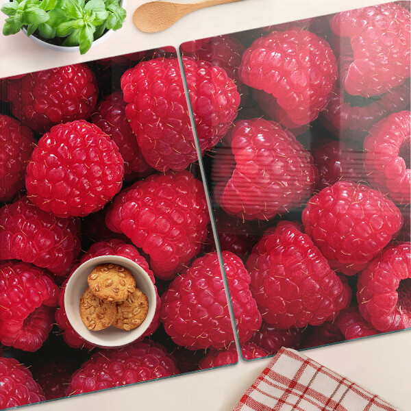 Planche à découper verre Des framboises en arrière-plan