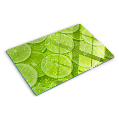 Planche à découper verre Tranches de citron vert sur fond vert