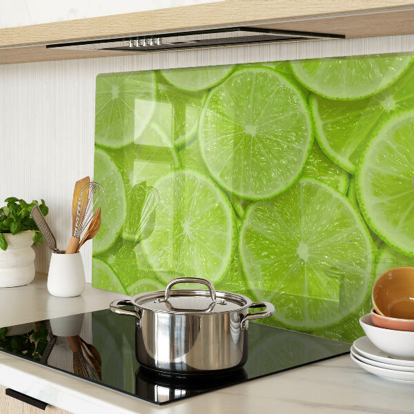 Planche à découper verre Tranches de citron vert sur fond vert