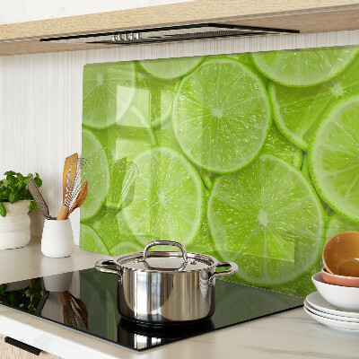 Planche à découper verre Tranches de citron vert sur fond vert