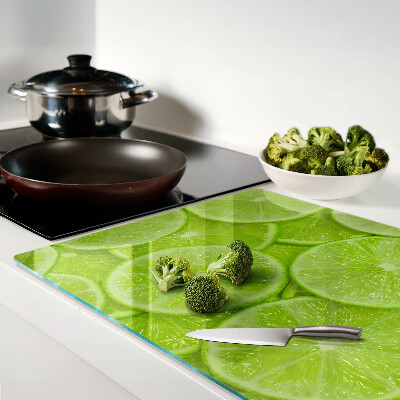 Planche à découper verre Tranches de citron vert sur fond vert