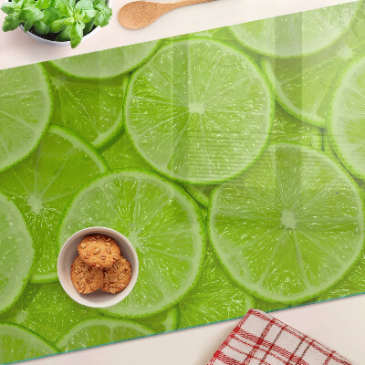 Planche à découper verre Tranches de citron vert sur fond vert