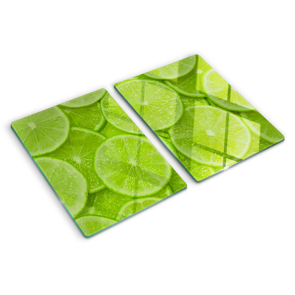 Planche à découper verre Tranches de citron vert sur fond vert