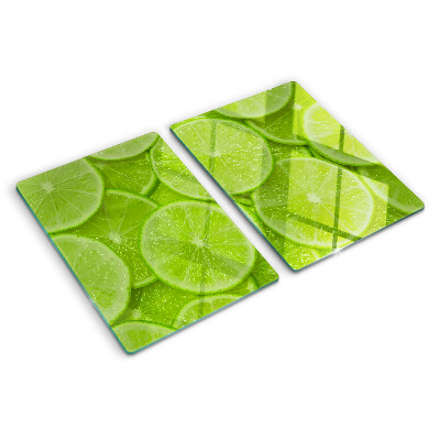 Planche à découper verre Tranches de citron vert sur fond vert