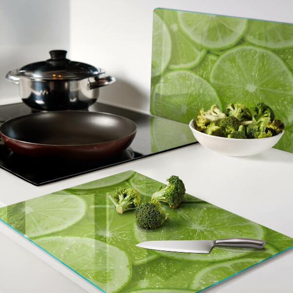 Planche à découper verre Tranches de citron vert sur fond vert