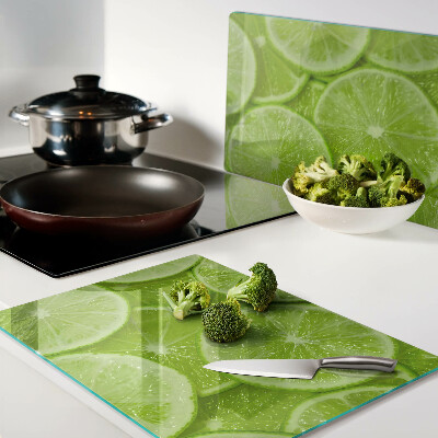 Planche à découper verre Tranches de citron vert sur fond vert