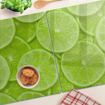 Planche à découper verre Tranches de citron vert sur fond vert