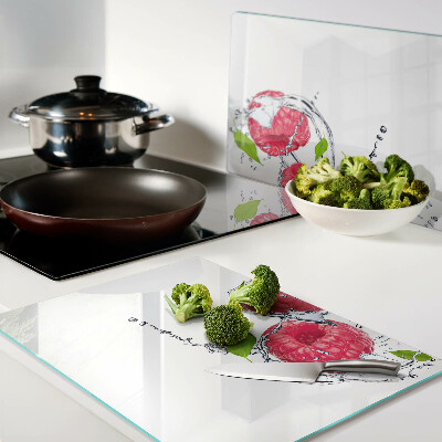 Planche à découper en verre Framboises dans l'eau avec des feuilles