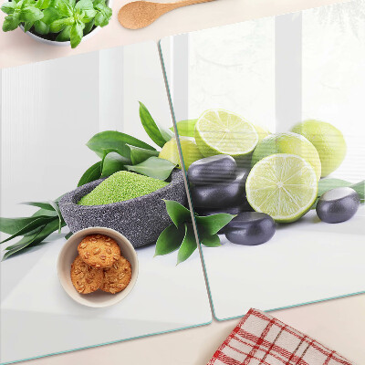 Planche à découper en verre Citrons et raisins sur fond vert